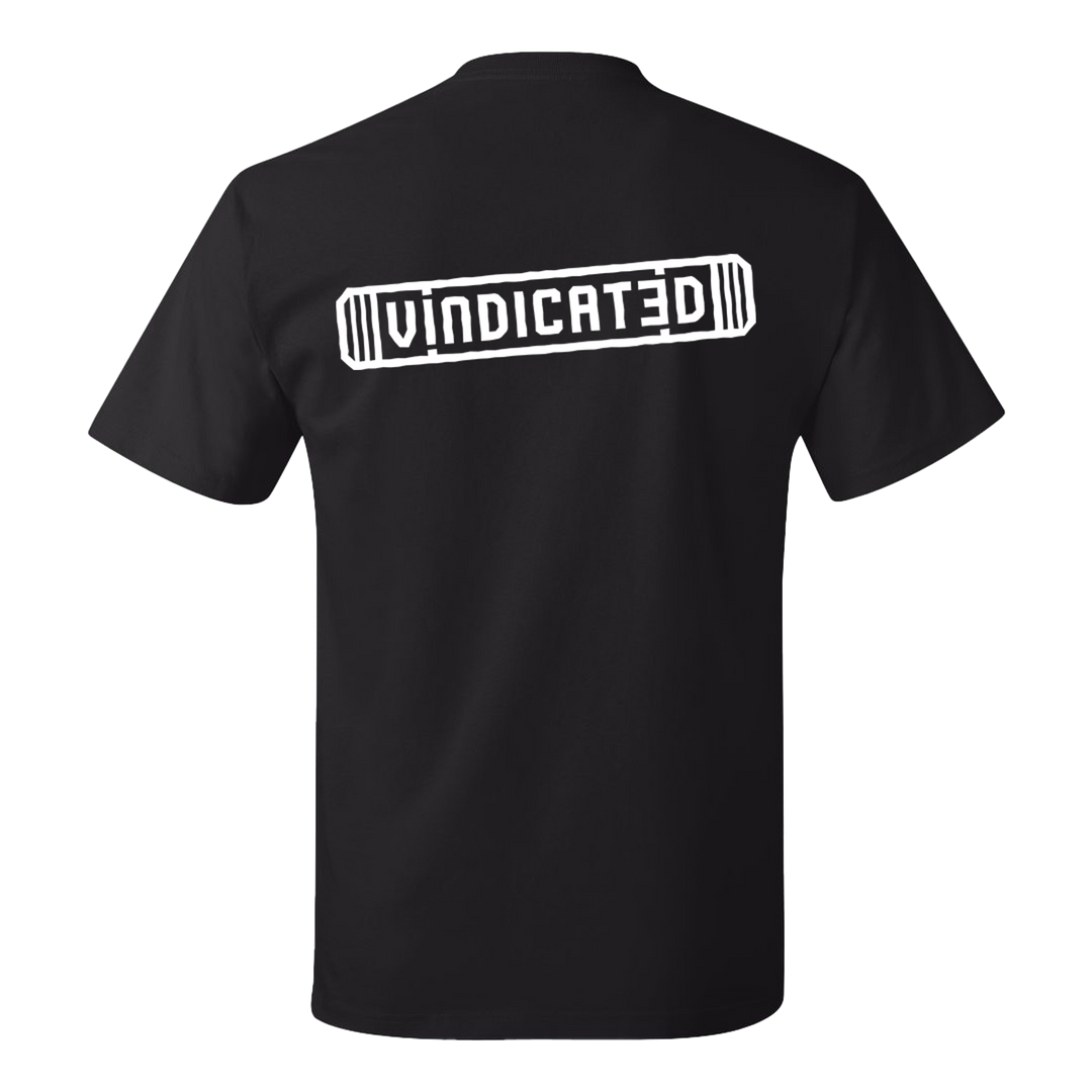 Backside of the Black Vindicated tee shirt with "Vindicated" in white across the middle of the back inside a skateboard